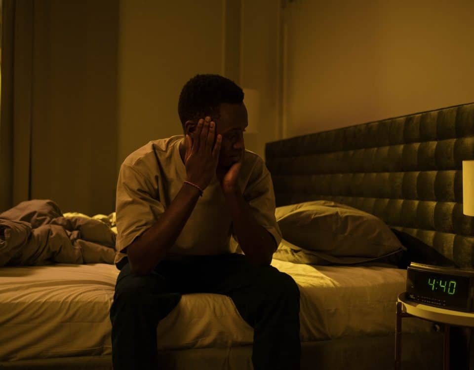 A Man Sitting on a Bed